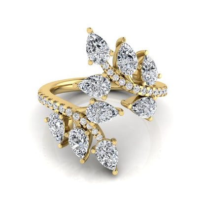 Pear and round cut lab grown diamond floral bypass ring featuring leaf-inspired clusters with pavé diamond accents in yellow gold