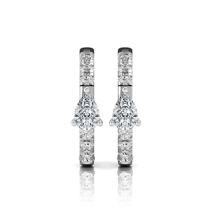 Pear and round cut lab grown diamond pavé huggie hoop earrings featuring a three prong pear diamond center, shared prong round diamond accents, hinged snap closure, and polished white gold finish.