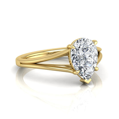 Pear cut lab grown diamond solitaire engagement ring with an elegant split shank and classic prong setting in yellow gold