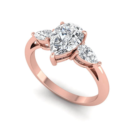 Pear three stone lab grown diamond engagement ring featuring a 1.33 carat IGI certified pear cut center diamond with pear cut side diamonds in rose gold.