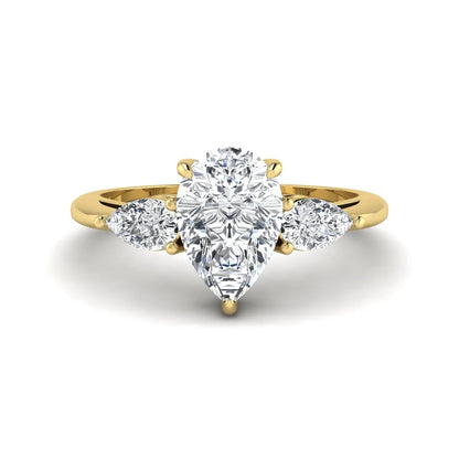 Pear three stone lab grown diamond engagement ring featuring a 1.33 carat IGI certified pear cut center diamond with pear cut side diamonds in yellow gold.
