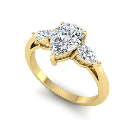 Pear three stone lab grown diamond engagement ring featuring a 1.33 carat IGI certified pear cut center diamond with pear cut side diamonds in yellow gold.