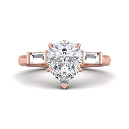 Pear cut lab grown diamond three stone engagement ring with baguette side diamonds in a classic prong setting in rose gold