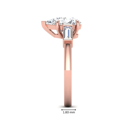 Pear cut lab grown diamond three stone engagement ring with baguette side diamonds in a classic prong setting in rose gold