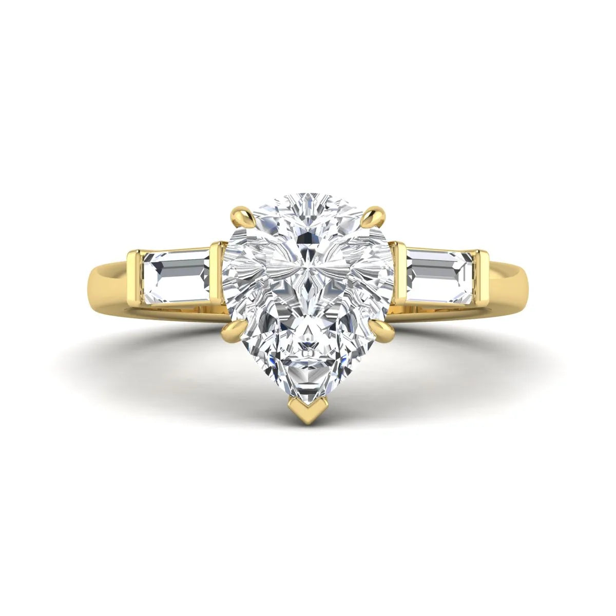 Pear cut lab grown diamond three stone engagement ring with baguette side diamonds in a classic prong setting in yellow gold