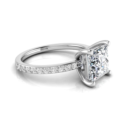 Princess cut four prong lab grown diamond engagement ring featuring a 1.96 carat IGI certified center diamond with round cut pavé diamonds on a classic solitaire band in white gold