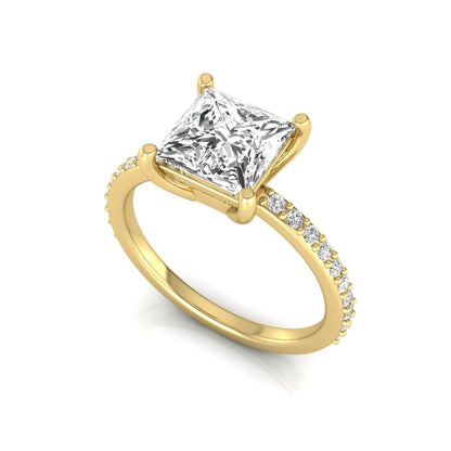 Princess cut four prong lab grown diamond engagement ring featuring a 1.96 carat IGI certified center diamond with round cut pavé diamonds on a classic solitaire band in yellow gold