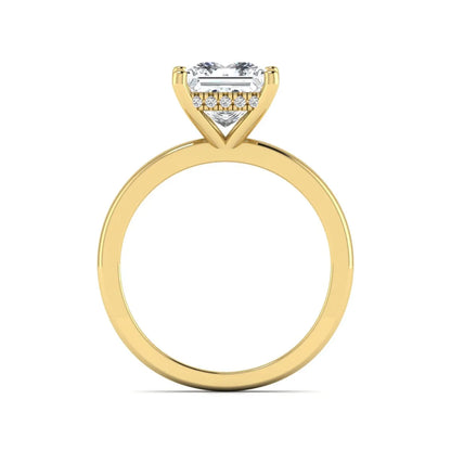 Princess cut lab grown diamond hidden halo solitaire engagement ring with four-prong setting and yellow gold tone band.
