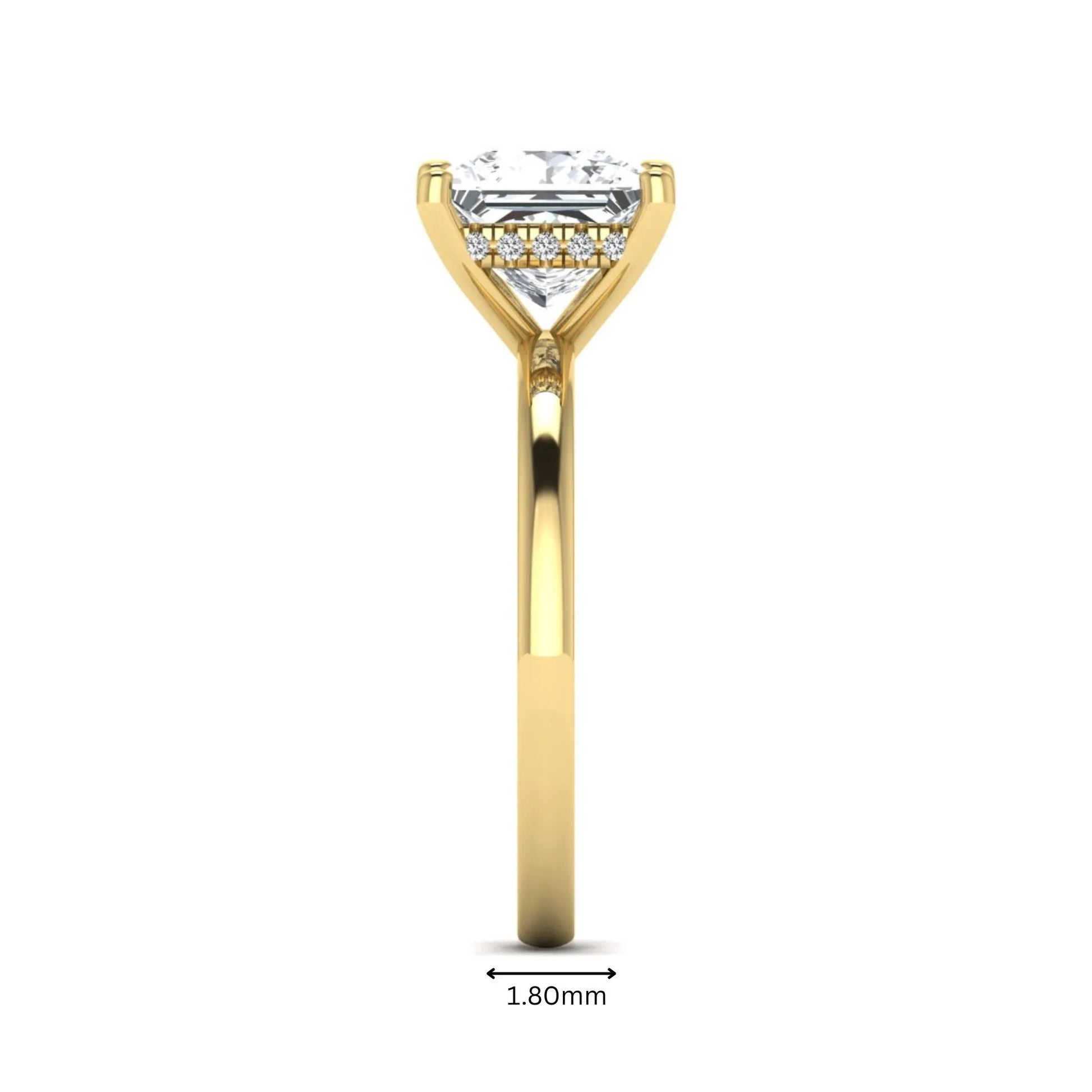 Princess cut lab grown diamond hidden halo solitaire engagement ring with four-prong setting and yellow gold tone band.