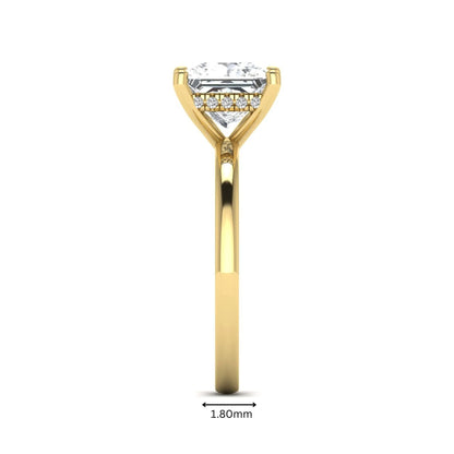 Princess cut lab grown diamond hidden halo solitaire engagement ring with four-prong setting and yellow gold tone band.