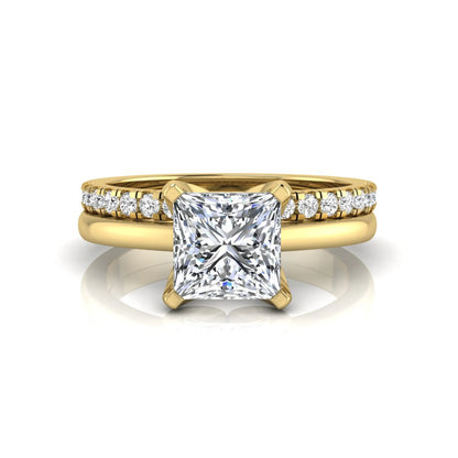 Princess cut lab grown diamond bridal ring set with matching pavé diamond wedding band in yellow gold.