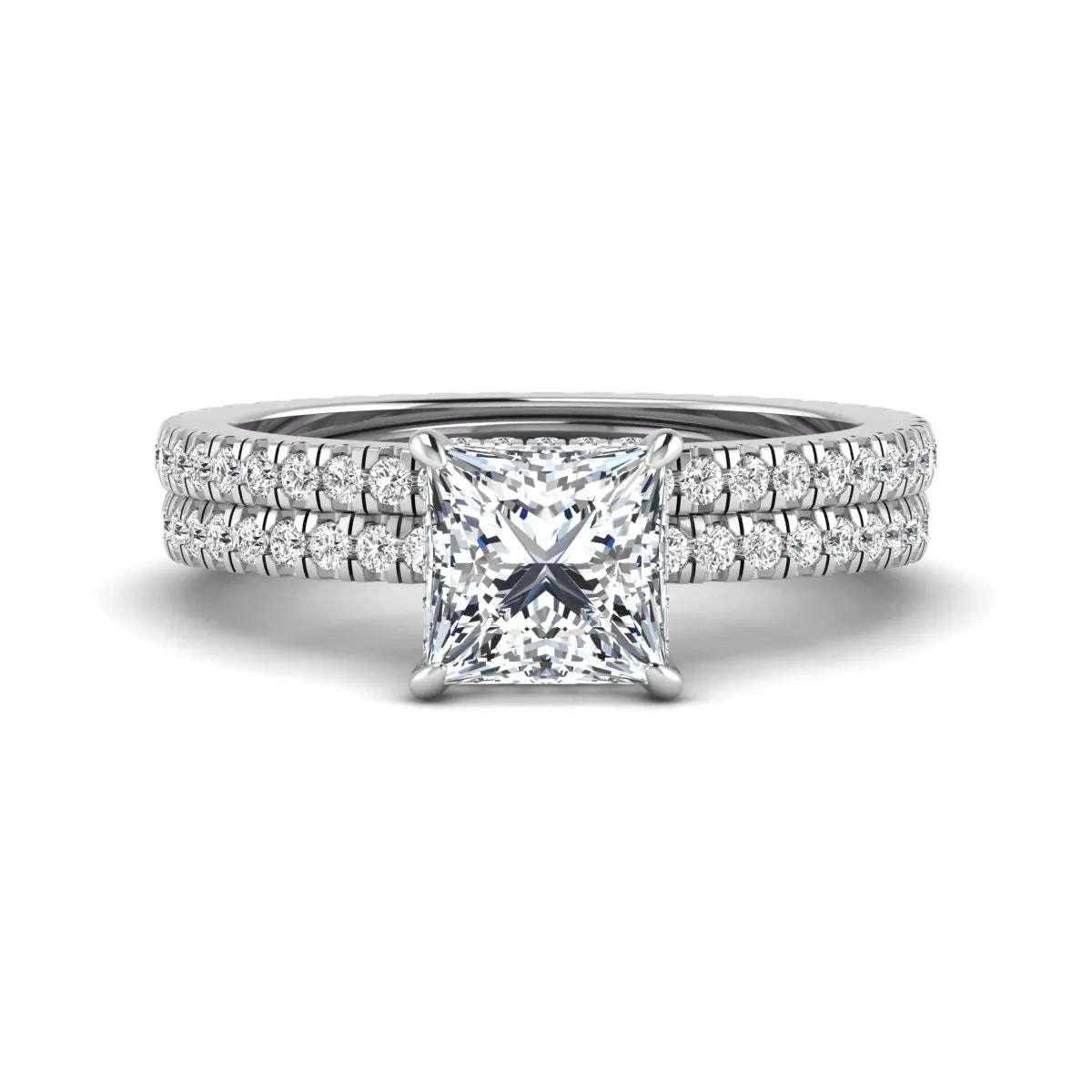 Princess cut lab grown diamond bridal ring set featuring a 1.96 carat IGI certified center diamond, hidden halo engagement ring, and matching round diamond eternity wedding band in white gold.