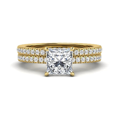 Princess cut lab grown diamond bridal ring set featuring a 1.96 carat IGI certified center diamond, hidden halo engagement ring, and matching round diamond eternity wedding band in yellow gold.