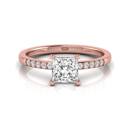 Princess cut lab grown diamond side stone engagement ring featuring a 1.24 carat IGI certified princess cut diamond with pavé round side diamonds in a rose gold setting.