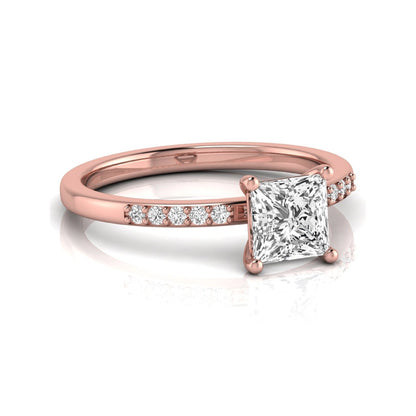 Princess cut lab grown diamond side stone engagement ring featuring a 1.24 carat IGI certified princess cut diamond with pavé round side diamonds in a rose gold setting.