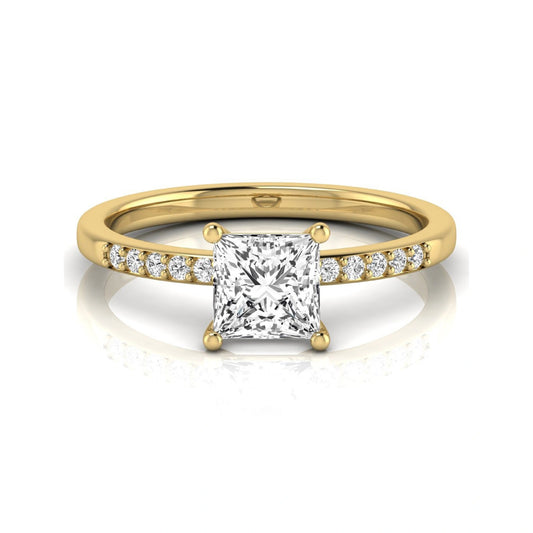 Princess cut lab grown diamond side stone engagement ring featuring a 1.24 carat IGI certified princess cut diamond with pavé round side diamonds in a yellow gold setting.