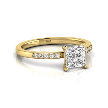 Princess cut lab grown diamond side stone engagement ring featuring a 1.24 carat IGI certified princess cut diamond with pavé round side diamonds in a yellow gold setting.
