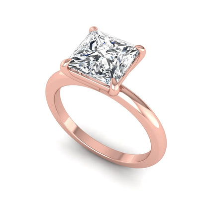 Princess cut lab grown diamond solitaire engagement ring with four-prong setting and rose gold tone band.