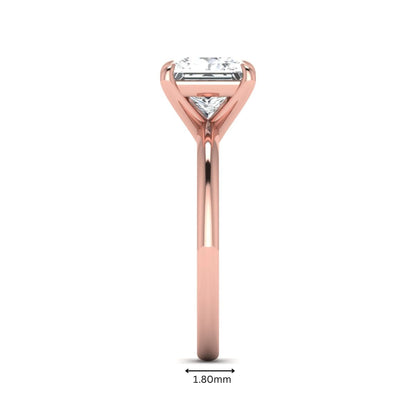 Princess cut lab grown diamond solitaire engagement ring with four-prong setting and rose gold tone band.