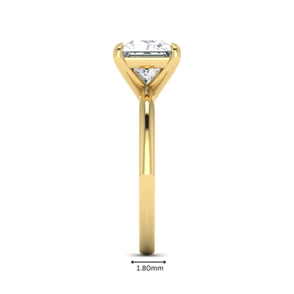 Princess cut lab grown diamond solitaire engagement ring with four-prong setting and yellow gold tone band.