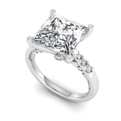 Princess cut lab grown diamond vintage solitaire engagement ring featuring a 4.12 carat IGI certified center diamond with vintage scrollwork and round diamond accents in white gold
