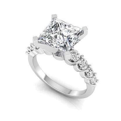 Princess cut lab grown diamond engagement ring with round side diamonds in white gold.