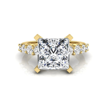Princess cut lab grown diamond engagement ring with round side diamonds in yellow gold.