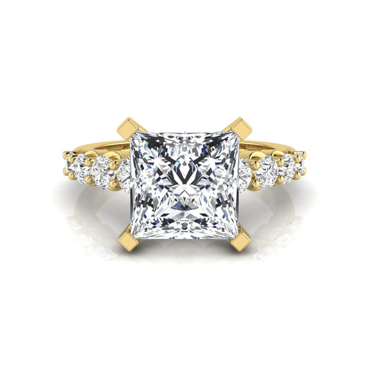 Princess cut lab grown diamond engagement ring with round side diamonds in yellow gold.