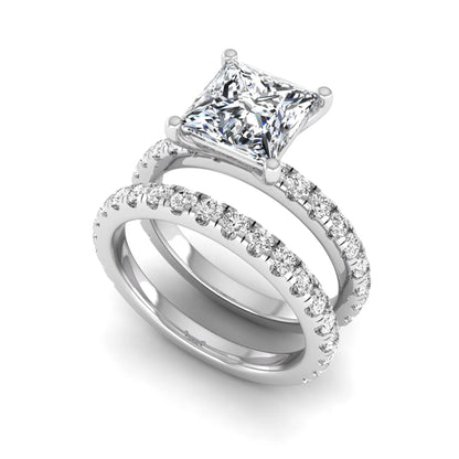 Princess Cut Solitaire Pavé Bridal Ring Set featuring a 7.00 mm IGI Certified lab grown diamond with matching round diamond pavé engagement ring and wedding band in white gold
