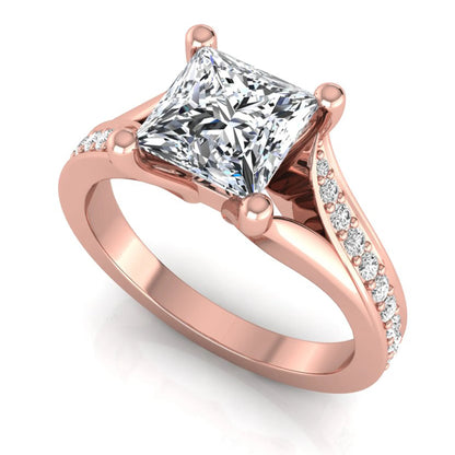 Princess cut lab grown diamond split shank engagement ring featuring a four-prong setting with round accent diamonds in a rose gold tone design.