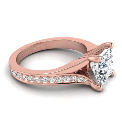 Princess cut lab grown diamond split shank engagement ring featuring a four-prong setting with round accent diamonds in a rose gold tone design.