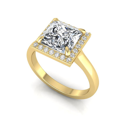 Princess cut lab grown diamond engagement ring featuring an IGI certified center diamond surrounded by a round diamond halo in a classic four-prong setting in yellow gold