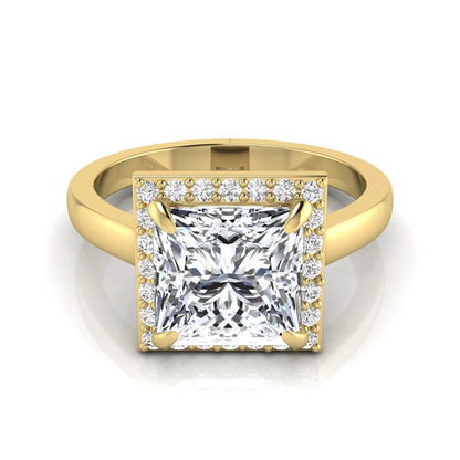 Princess cut lab grown diamond engagement ring featuring an IGI certified center diamond surrounded by a round diamond halo in a classic four-prong setting in yellow gold