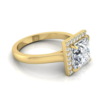 Princess cut lab grown diamond engagement ring featuring an IGI certified center diamond surrounded by a round diamond halo in a classic four-prong setting in yellow gold