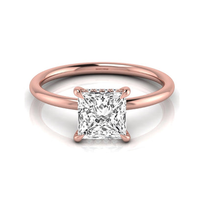 Princess cut lab grown diamond hidden halo solitaire engagement ring with a four-prong setting and rose gold tone band.