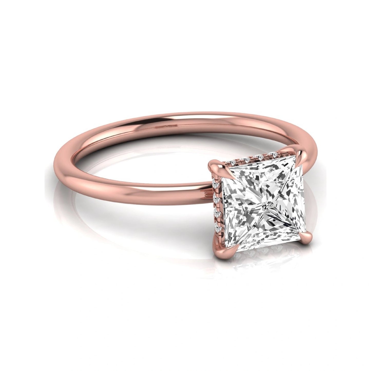 Princess cut lab grown diamond hidden halo solitaire engagement ring with a four-prong setting and rose gold tone band.