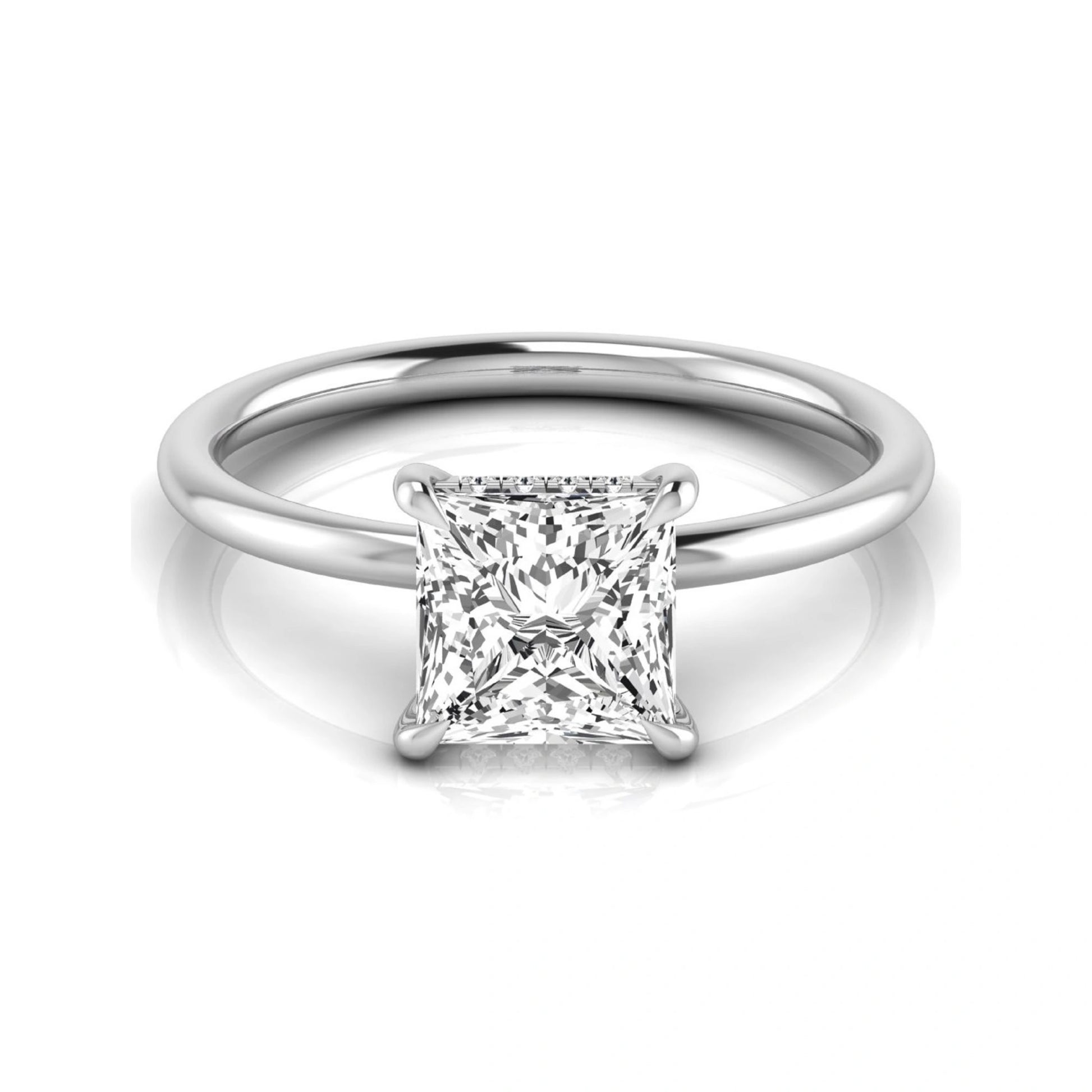 Princess cut lab grown diamond hidden halo solitaire engagement ring with a four-prong setting and white gold tone band.