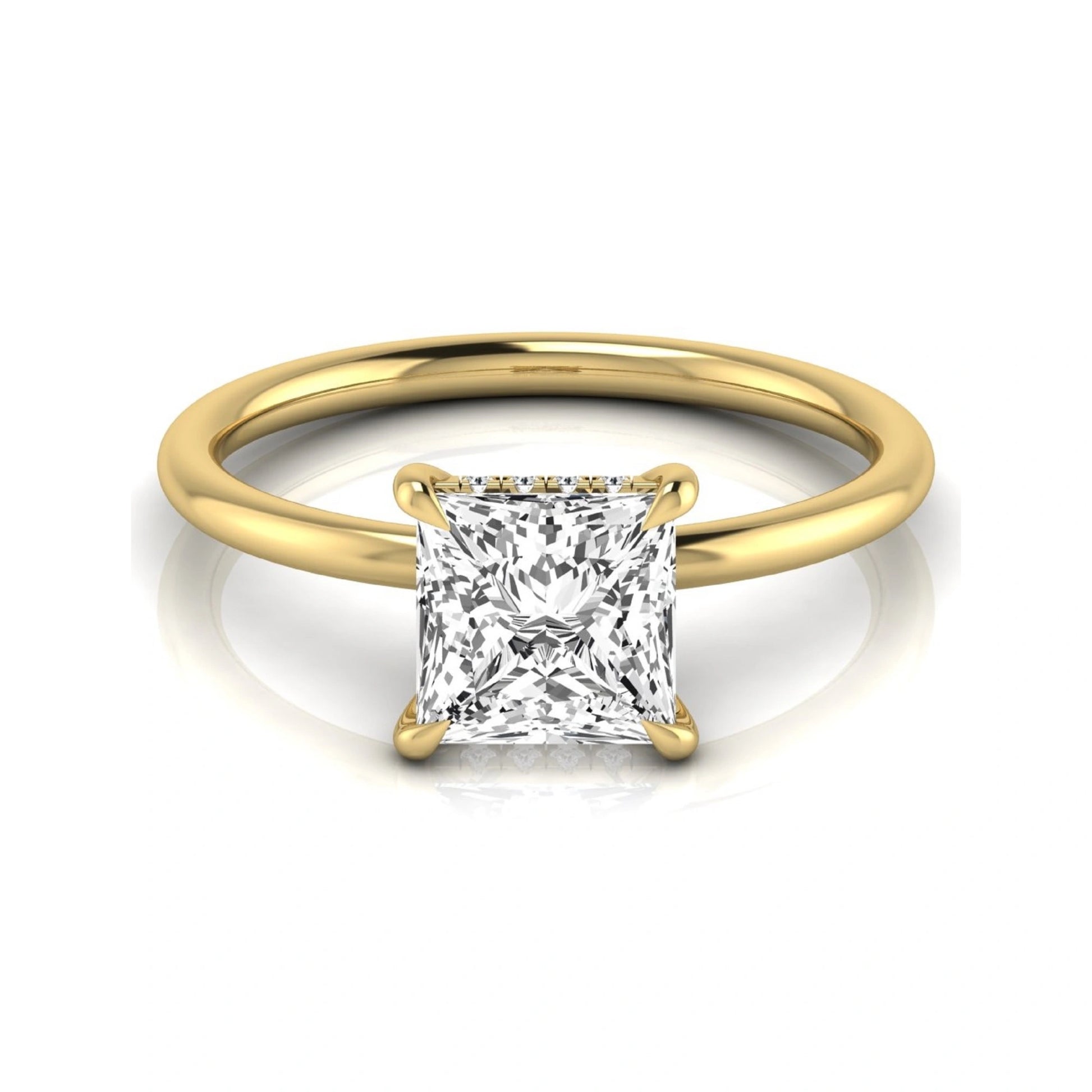 Princess cut lab grown diamond hidden halo solitaire engagement ring with a four-prong setting and yellow gold tone band.