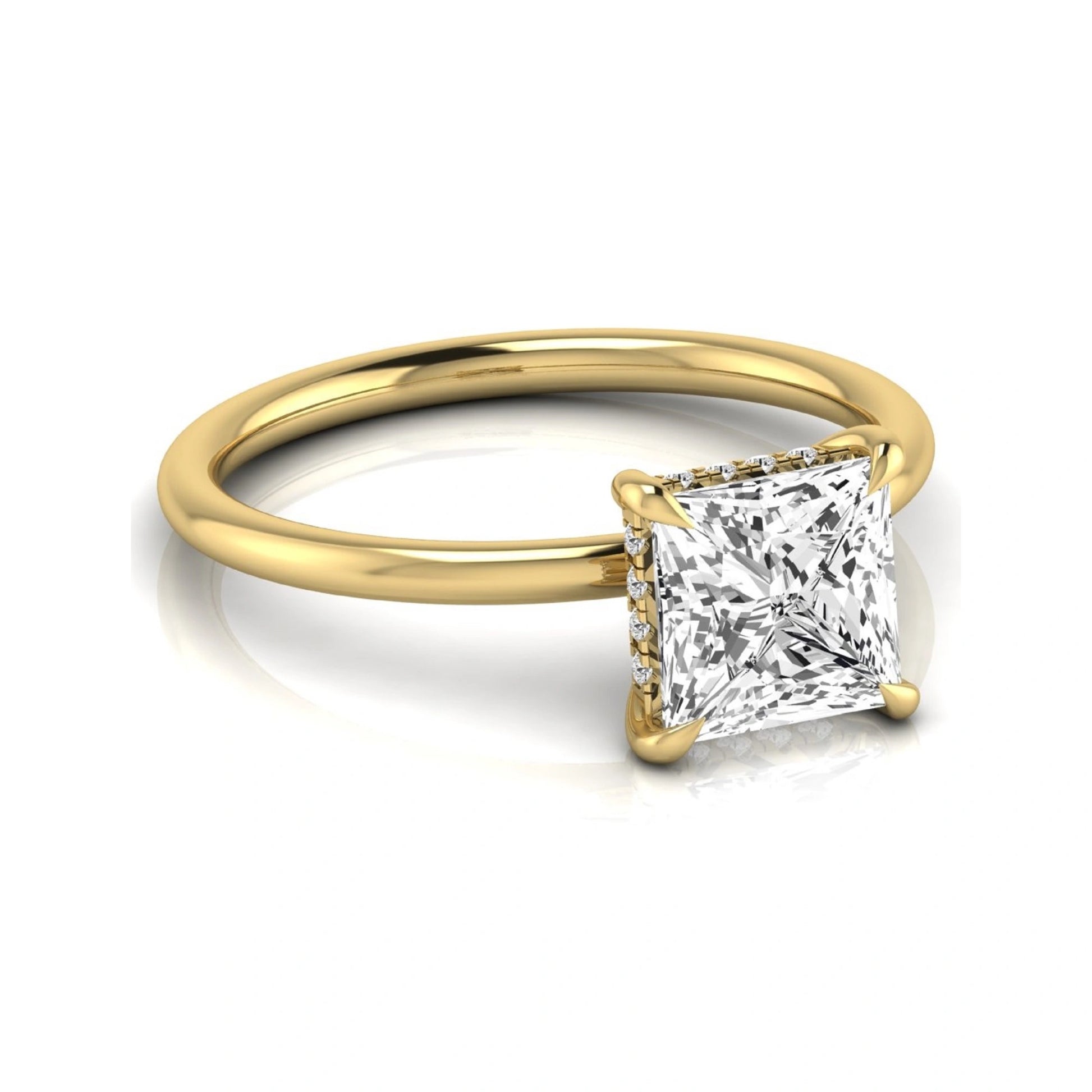 Princess cut lab grown diamond hidden halo solitaire engagement ring with a four-prong setting and yellow gold tone band.