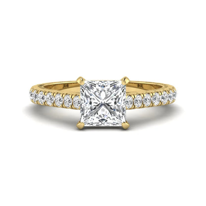 Princess cut lab grown diamond engagement ring with pavé round diamonds in a yellow gold four-prong setting