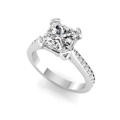 Princess cut lab grown diamond solitaire engagement ring featuring a four-prong setting with a pavé diamond band in white gold tone.
