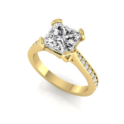 Princess cut lab grown diamond solitaire engagement ring featuring a four-prong setting with a pavé diamond band in yellow gold tone.