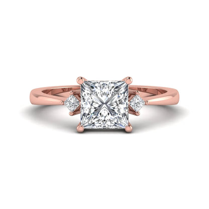 Princess cut lab grown diamond three stone engagement ring featuring a four-prong center diamond with princess cut side stones in rose gold.