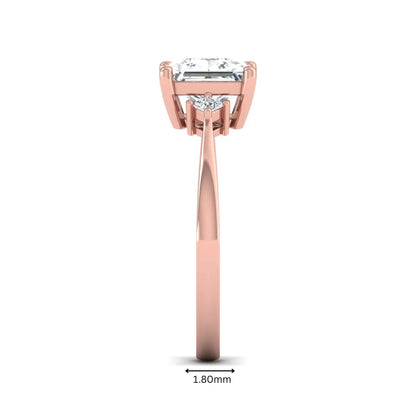 Princess cut lab grown diamond three stone engagement ring featuring a four-prong center diamond with princess cut side stones in rose gold.