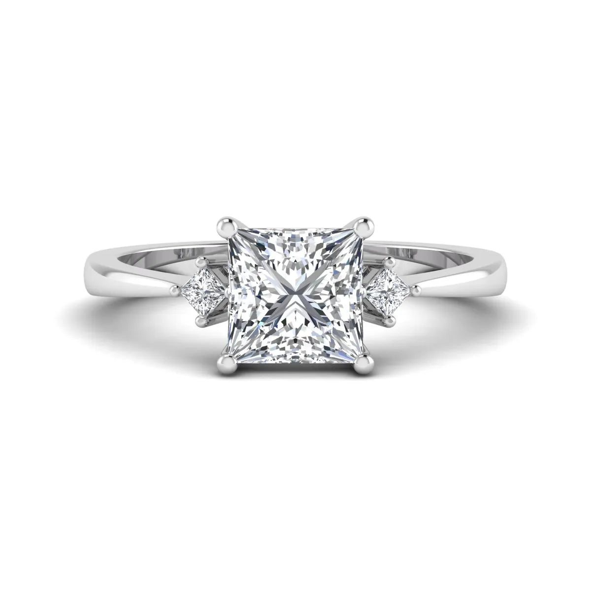 Princess cut lab grown diamond three stone engagement ring featuring a four-prong center diamond with princess cut side stones in white gold.