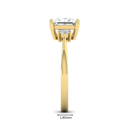 Princess cut lab grown diamond three stone engagement ring featuring a four-prong center diamond with princess cut side stones in yellow gold.