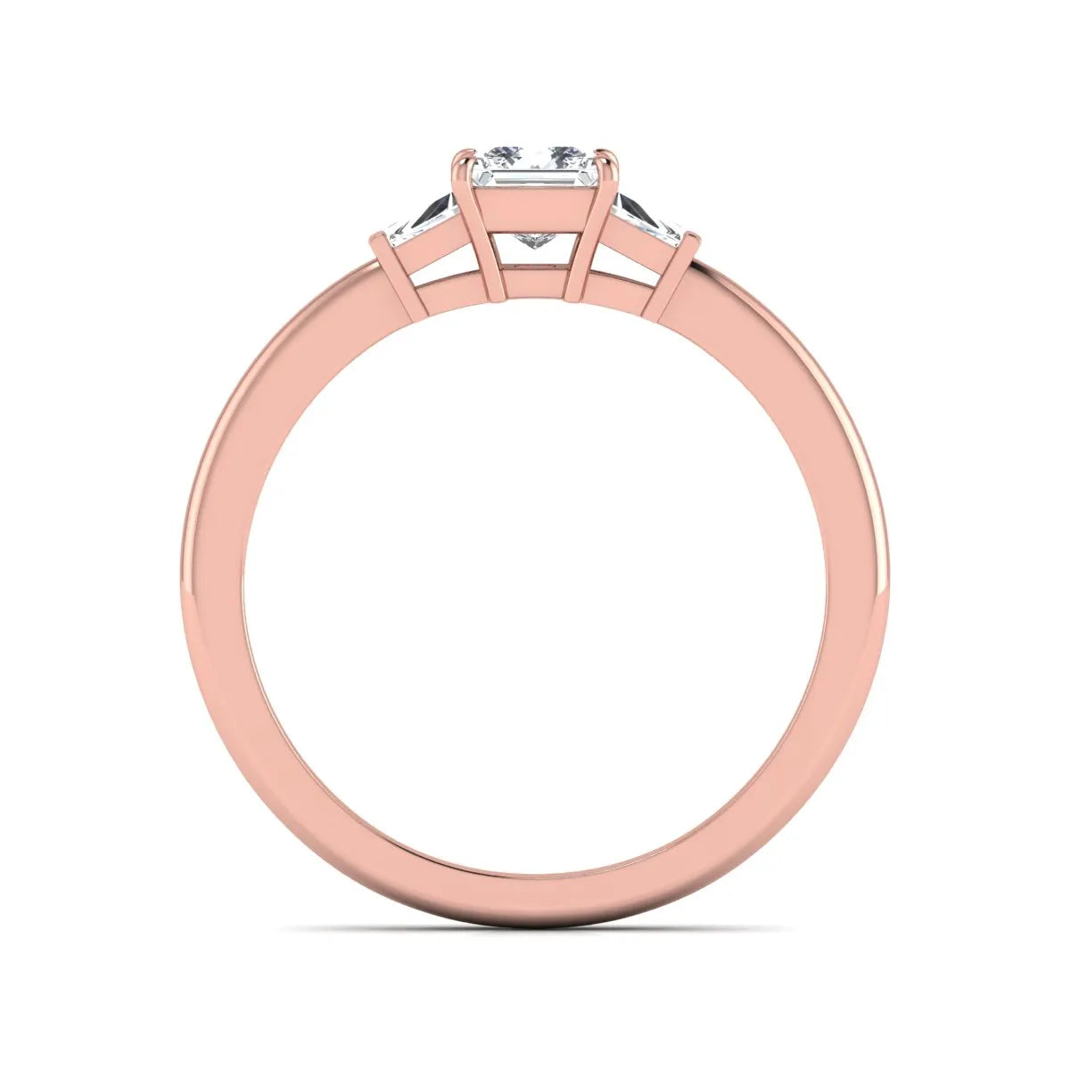 Princess cut lab grown diamond three stone engagement ring with tapered baguette side diamonds in a four-prong setting and rose gold tone band.