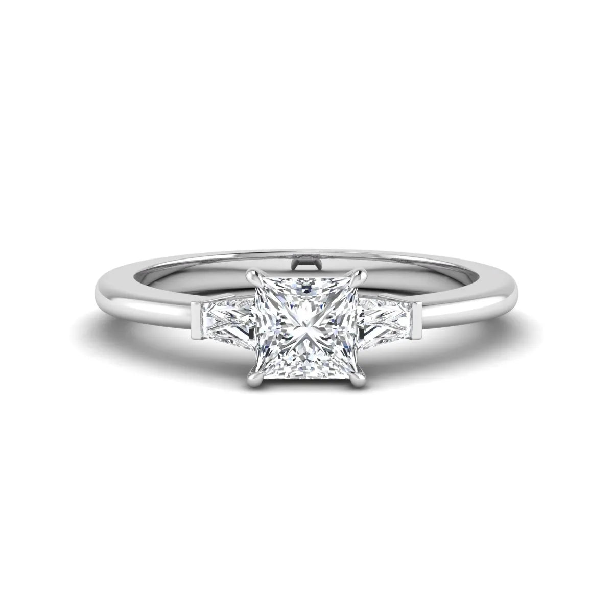 Princess cut lab grown diamond three stone engagement ring with tapered baguette side diamonds in a four-prong setting and white gold tone band.