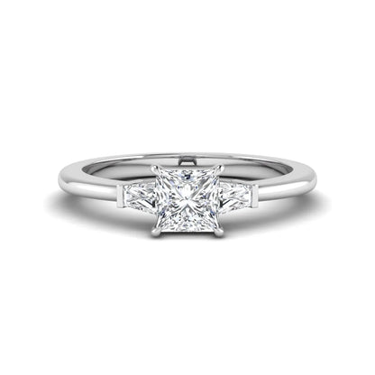 Princess cut lab grown diamond three stone engagement ring with tapered baguette side diamonds in a four-prong setting and white gold tone band.