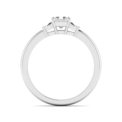 Princess cut lab grown diamond three stone engagement ring with tapered baguette side diamonds in a four-prong setting and white gold tone band.